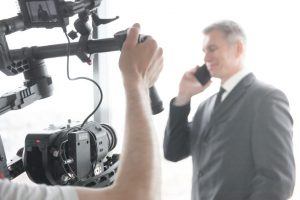 Videographer making video of businessman